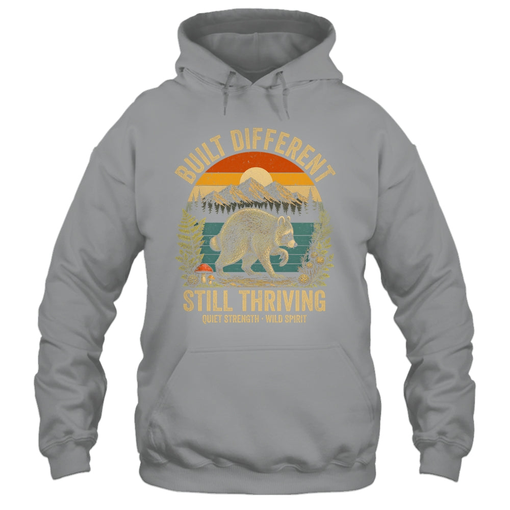 Built Different Still Thriving Raccoon Funny Vintage Shirt & Tank Top | teecentury
