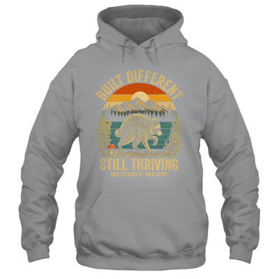 Built Different Still Thriving Raccoon Funny Vintage Shirt & Tank Top | teecentury
